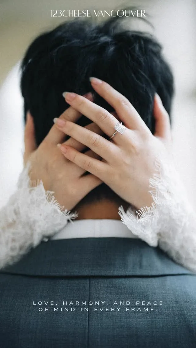 Bride's lace sleeves and hands around the back of the groom's head during an embrace.
