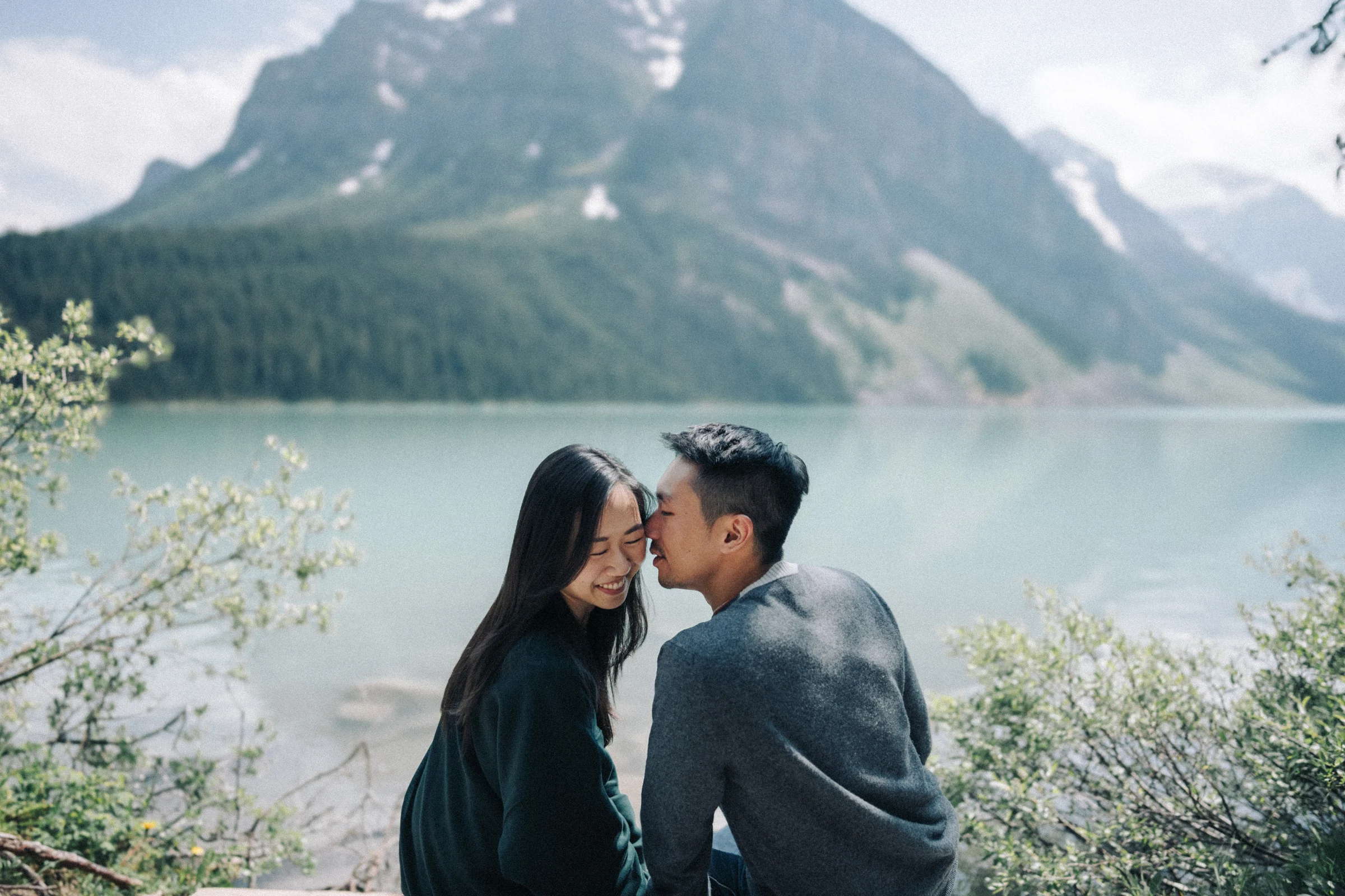 Desmond kisses Rachael beside Lake Louise in Banff National Park.