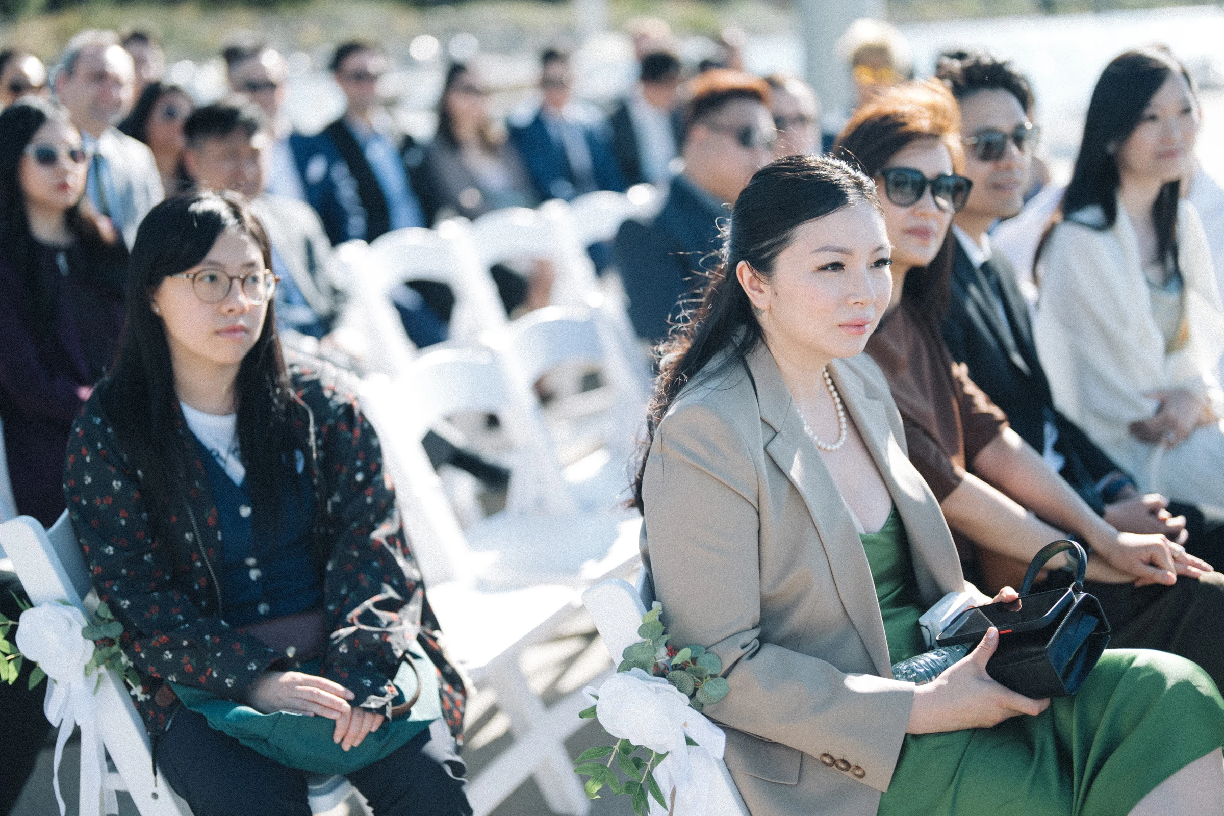 Seated guests watching the waterfront ceremony.