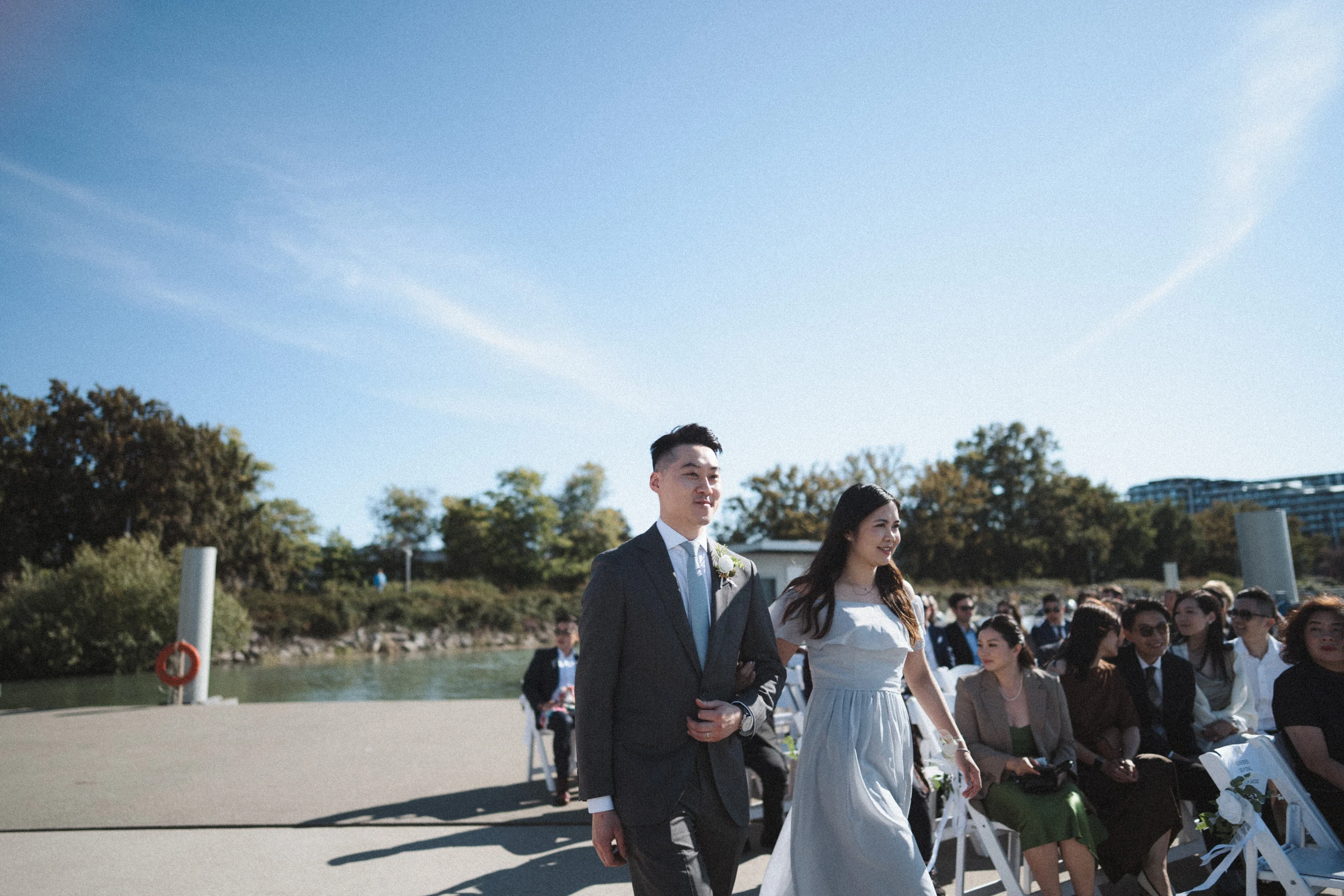 Two attendants walking together down the waterfront aisle.