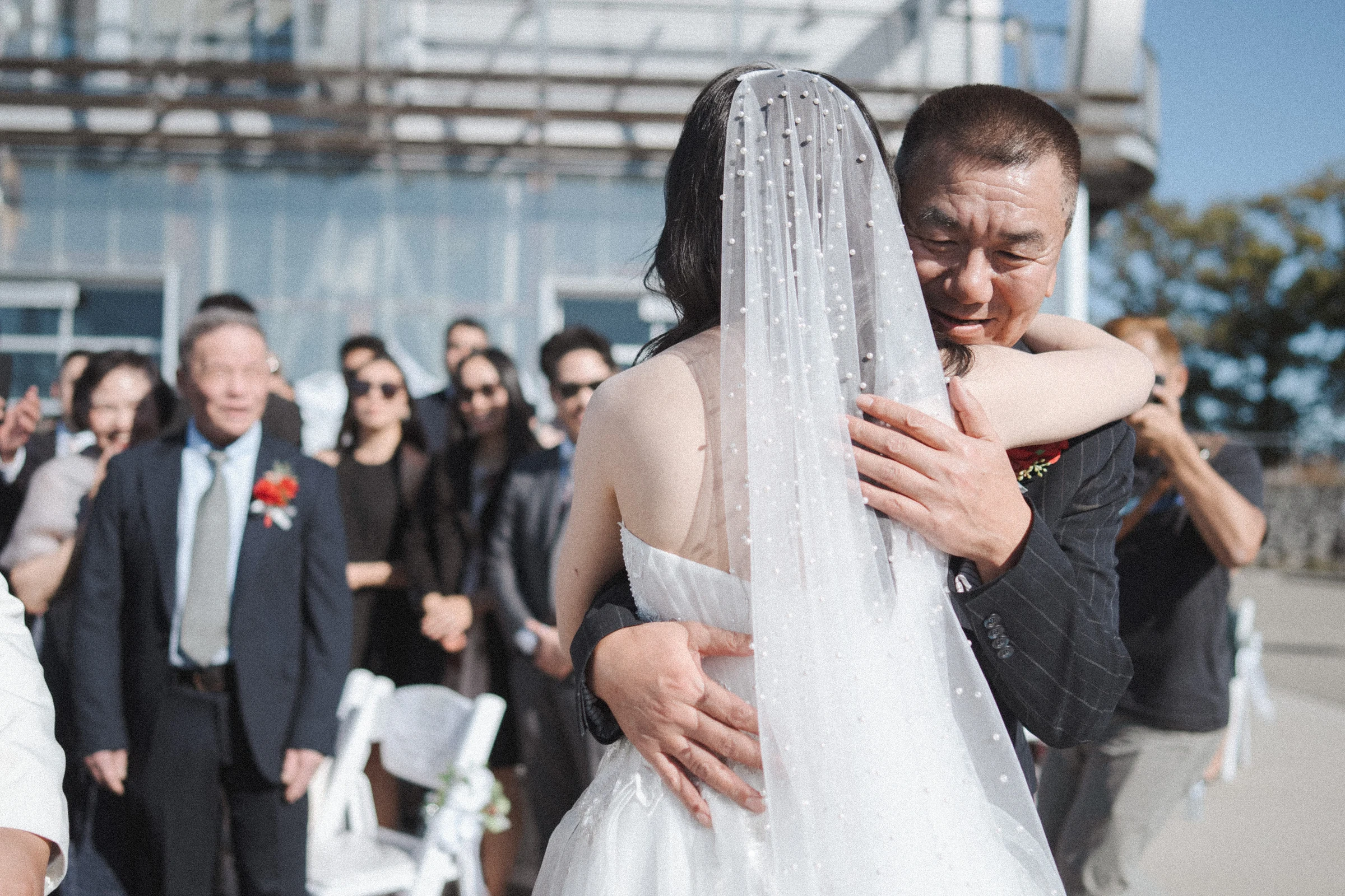Bride hugging a guest before the waterfront ceremony.
