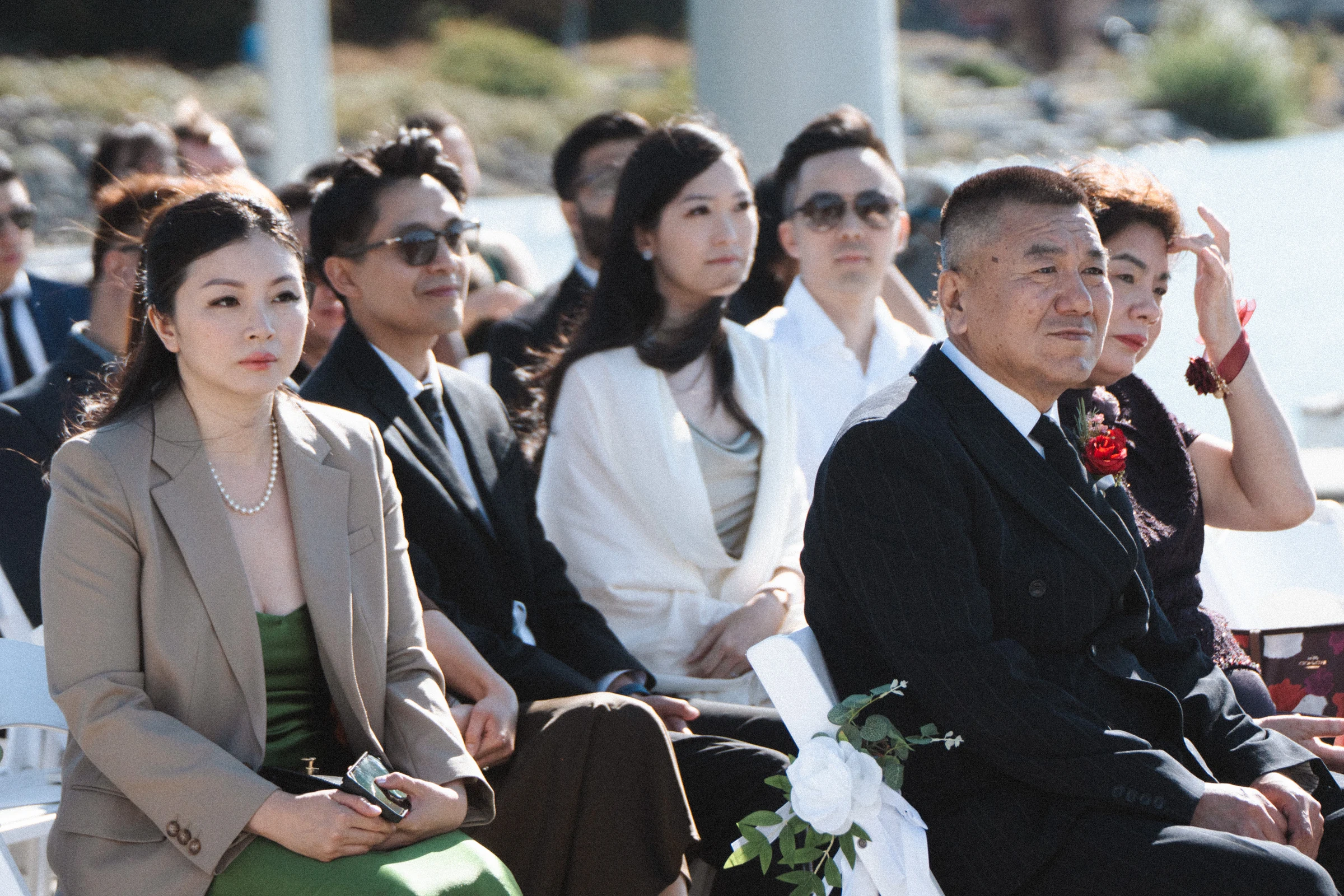 Family and friends listening from the waterfront ceremony chairs.