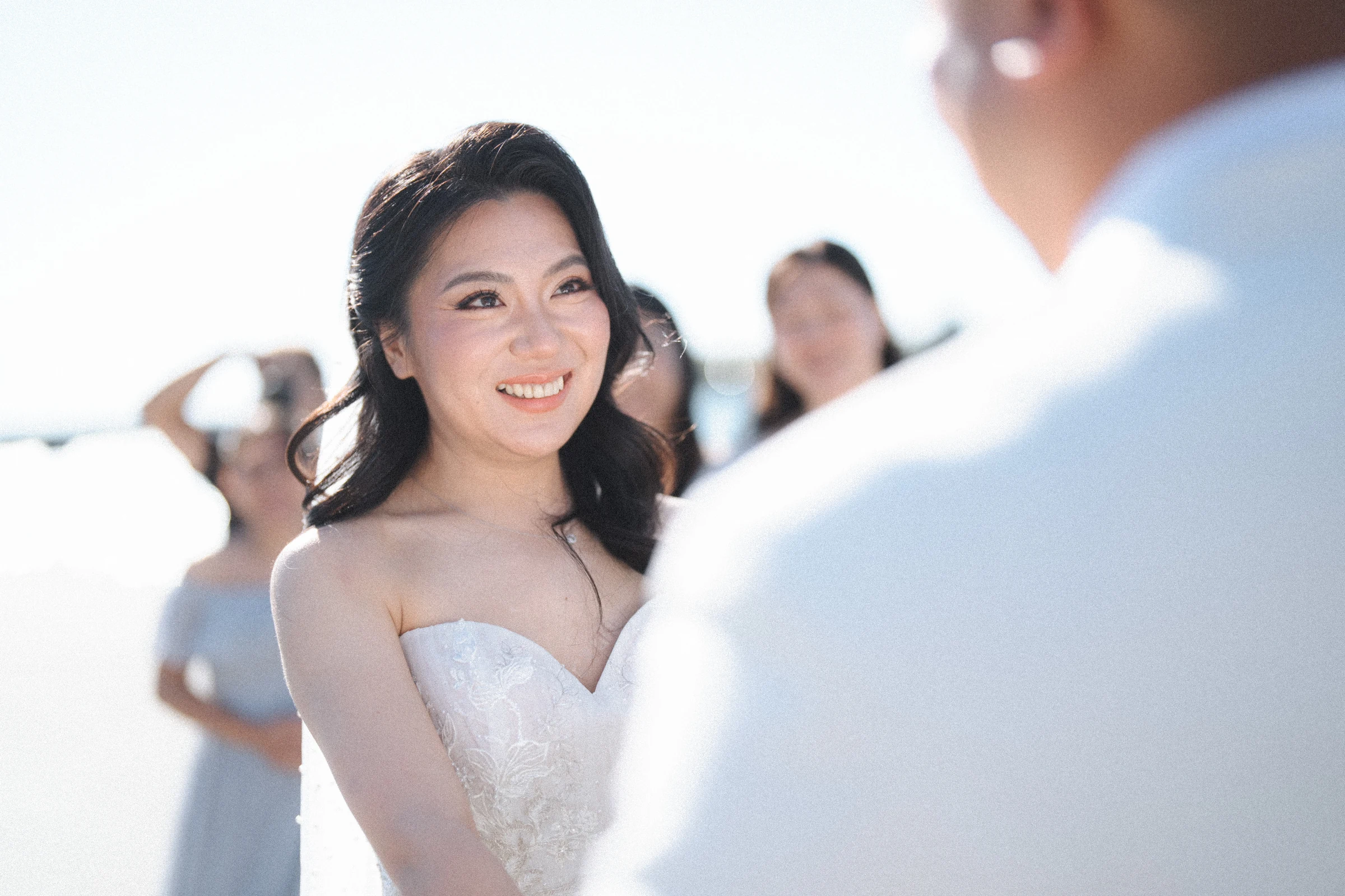 Close portrait of the bride speaking towards the groom.