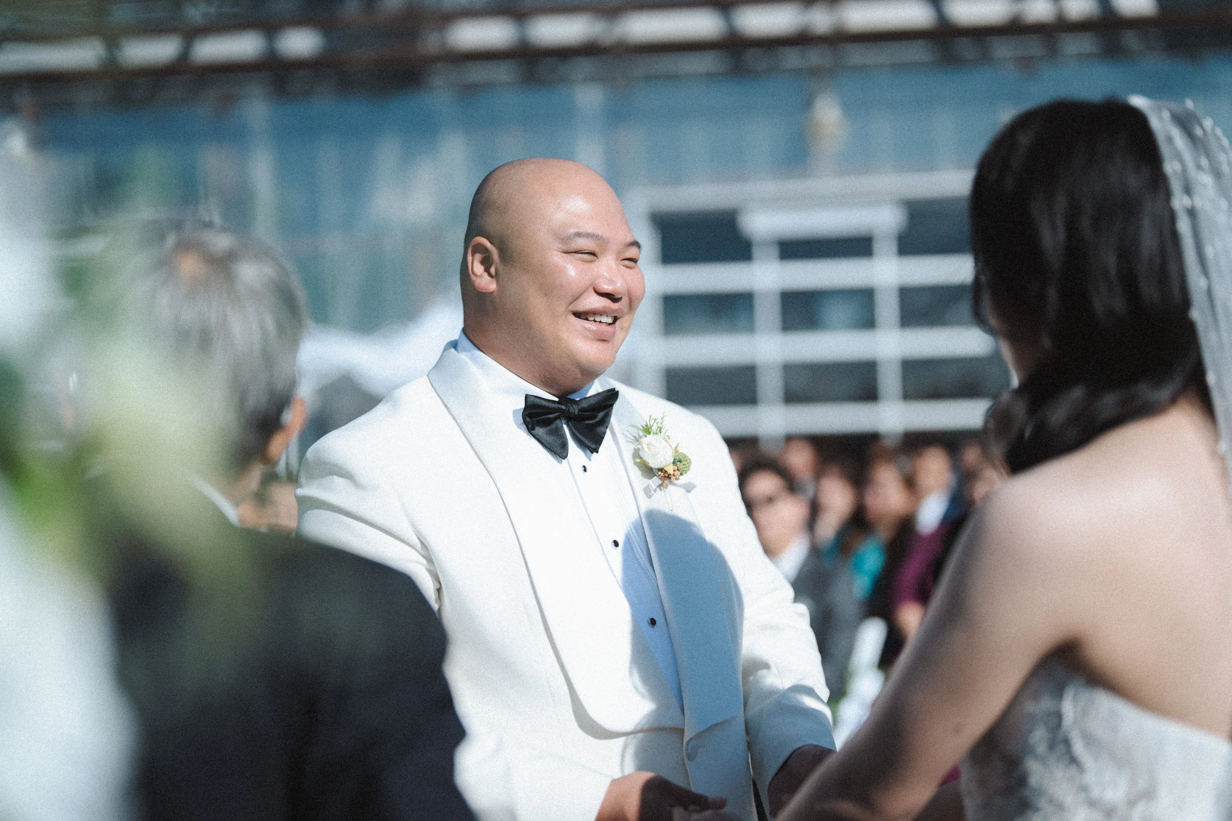 Groom smiling towards the bride during their vows.