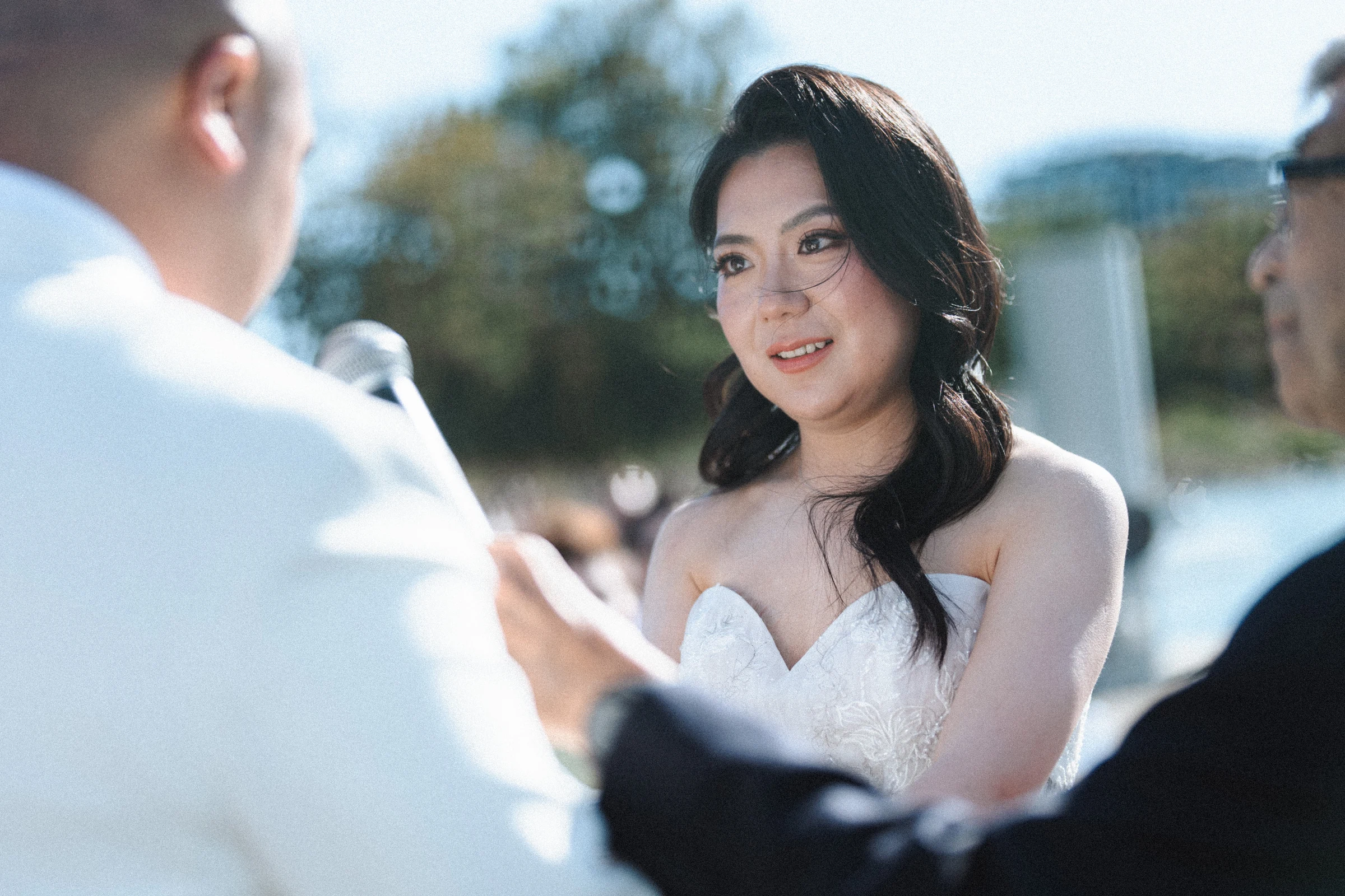Bride looking up at the groom as they stand together.