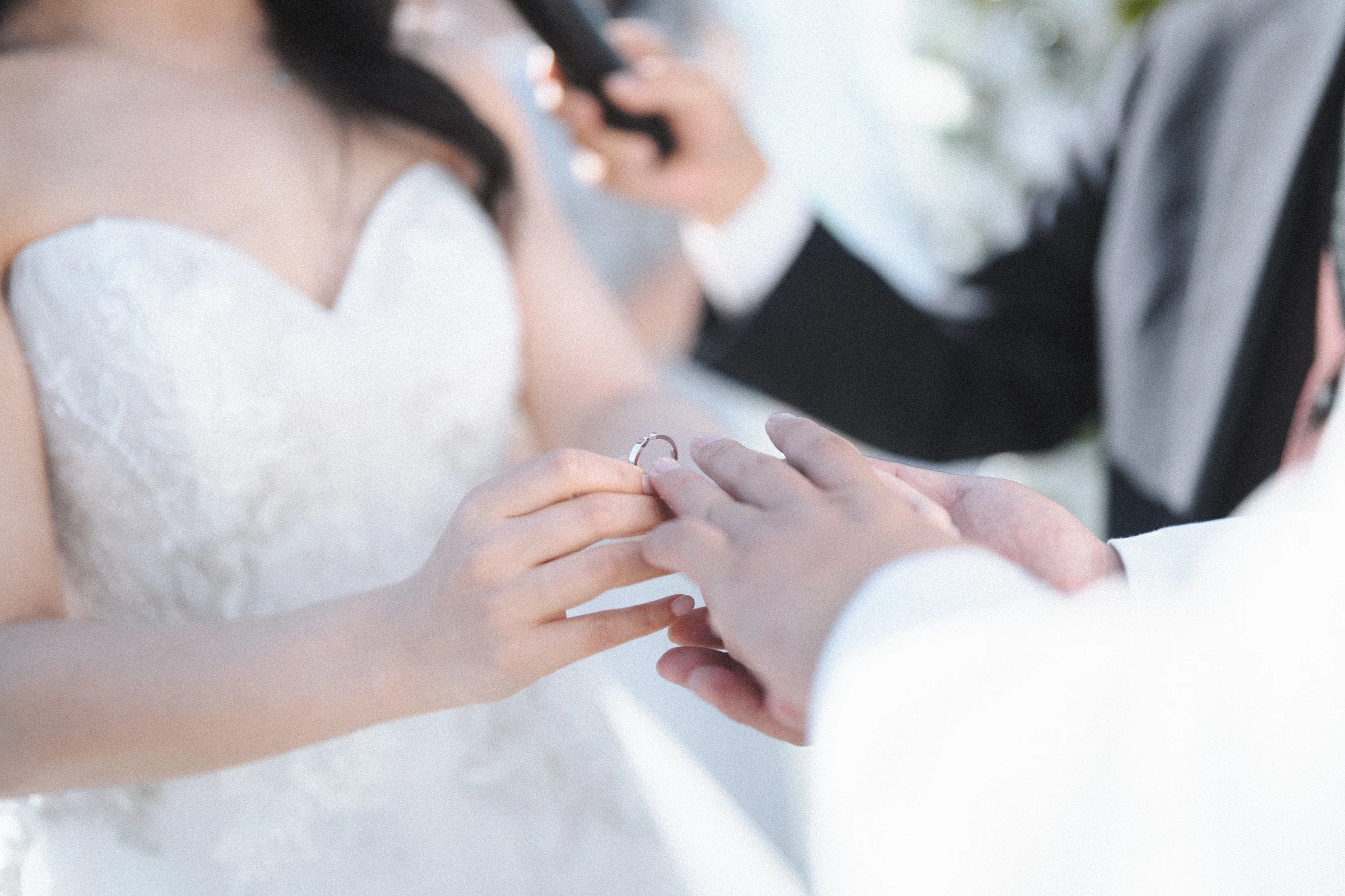 Close detail of hands during the ring exchange.