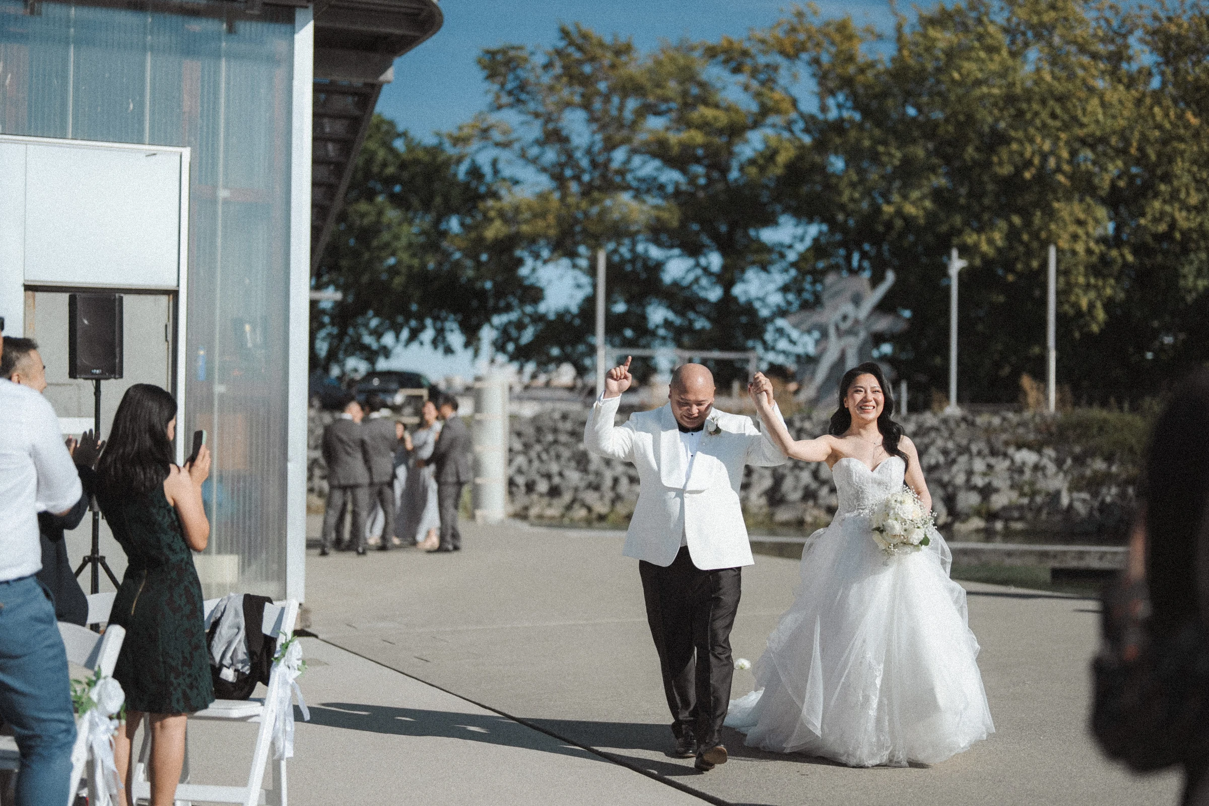 Couple walking together away from the ceremony chairs.