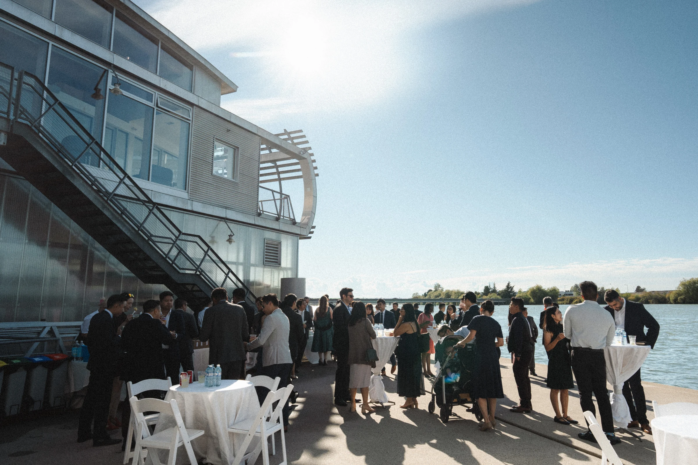 Guests gathering below the boathouse staircase after the ceremony.