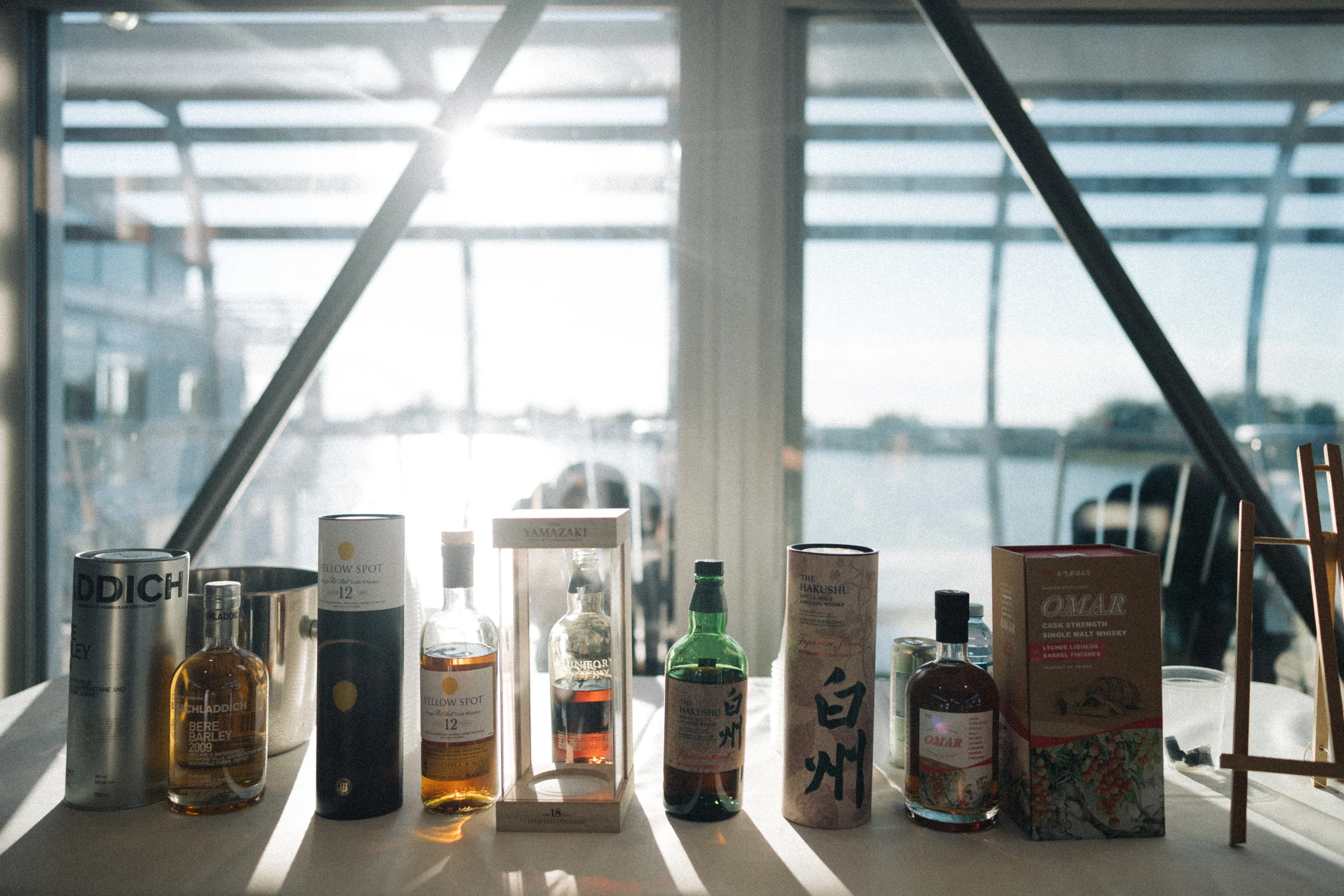 Drinks displayed on a table beside the boathouse windows.