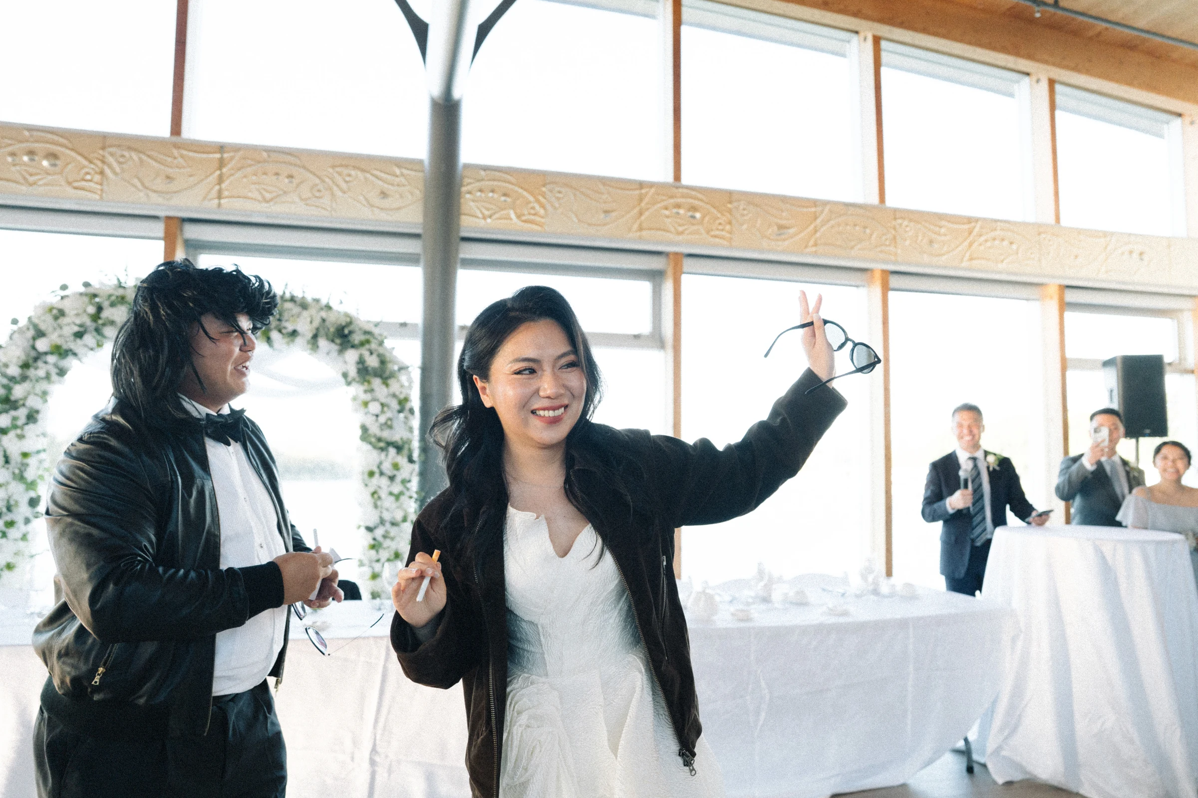 Two attendants in sunglasses enjoying their reception entrance.
