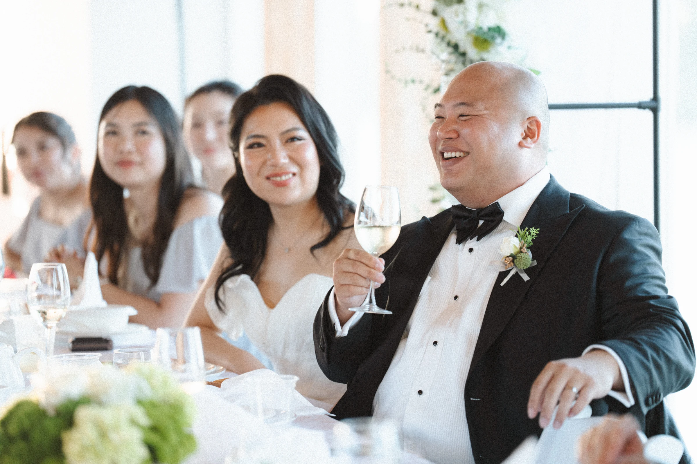Bride and groom seated together at the reception table.