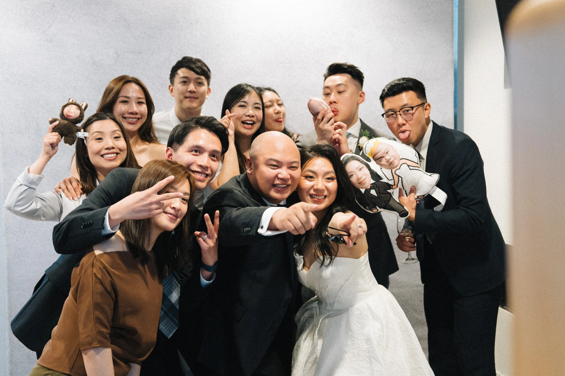 Friends crowding together around the bride for a cheerful group photograph.