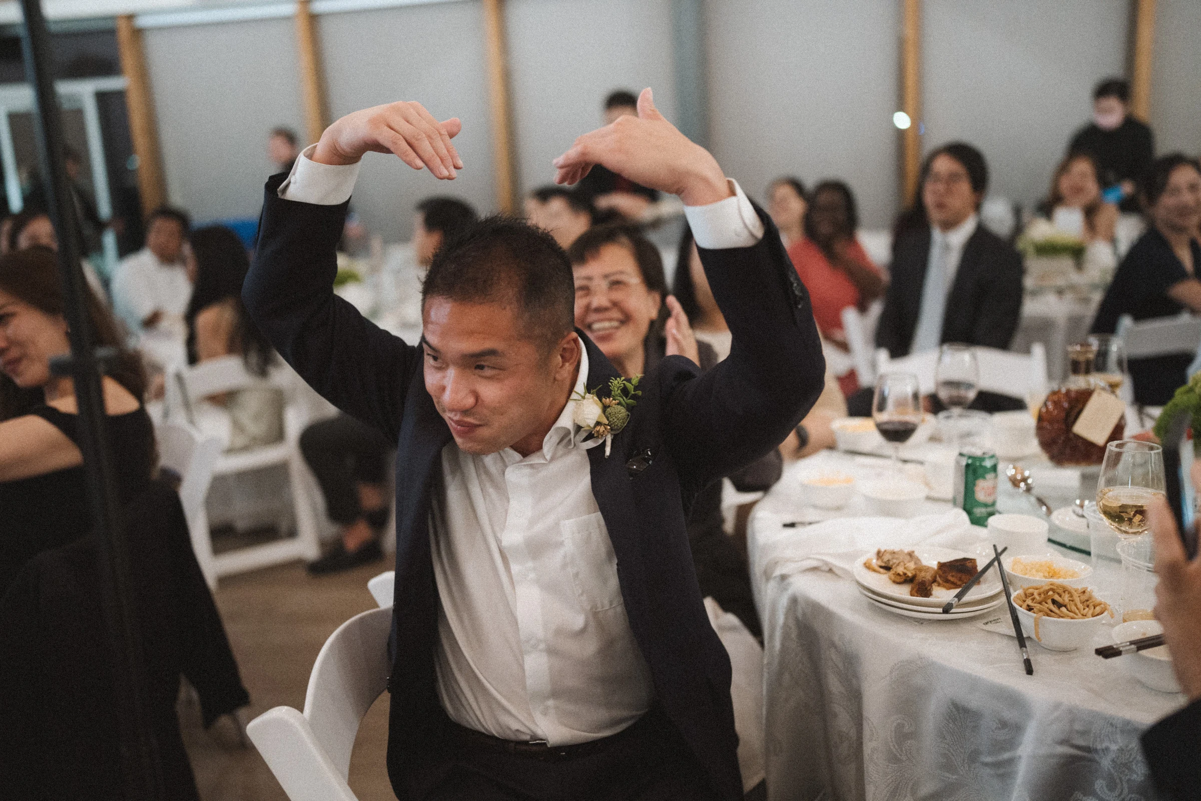 Guest raising his arms above his head during the reception.