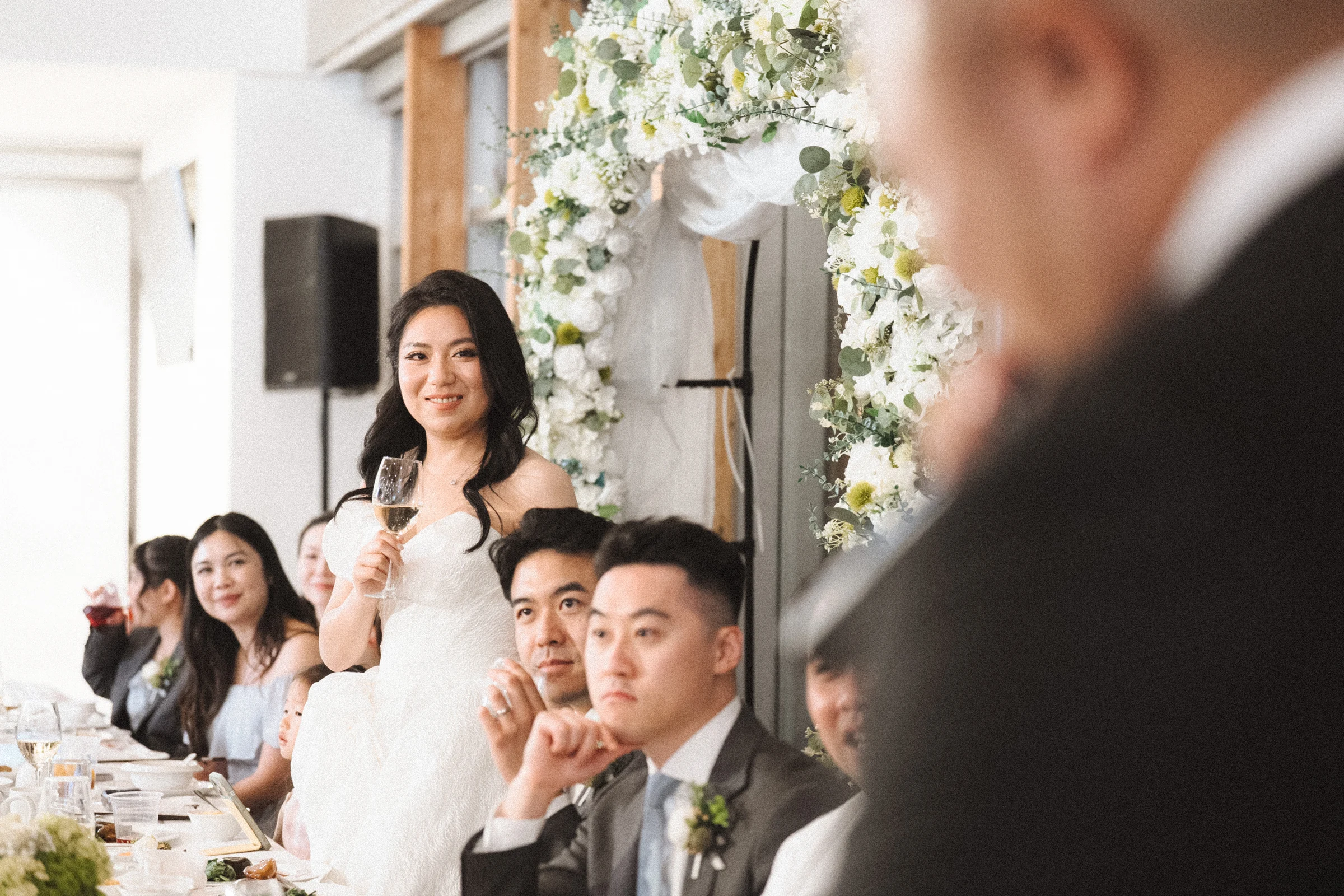 Bride speaking into a microphone at the reception.