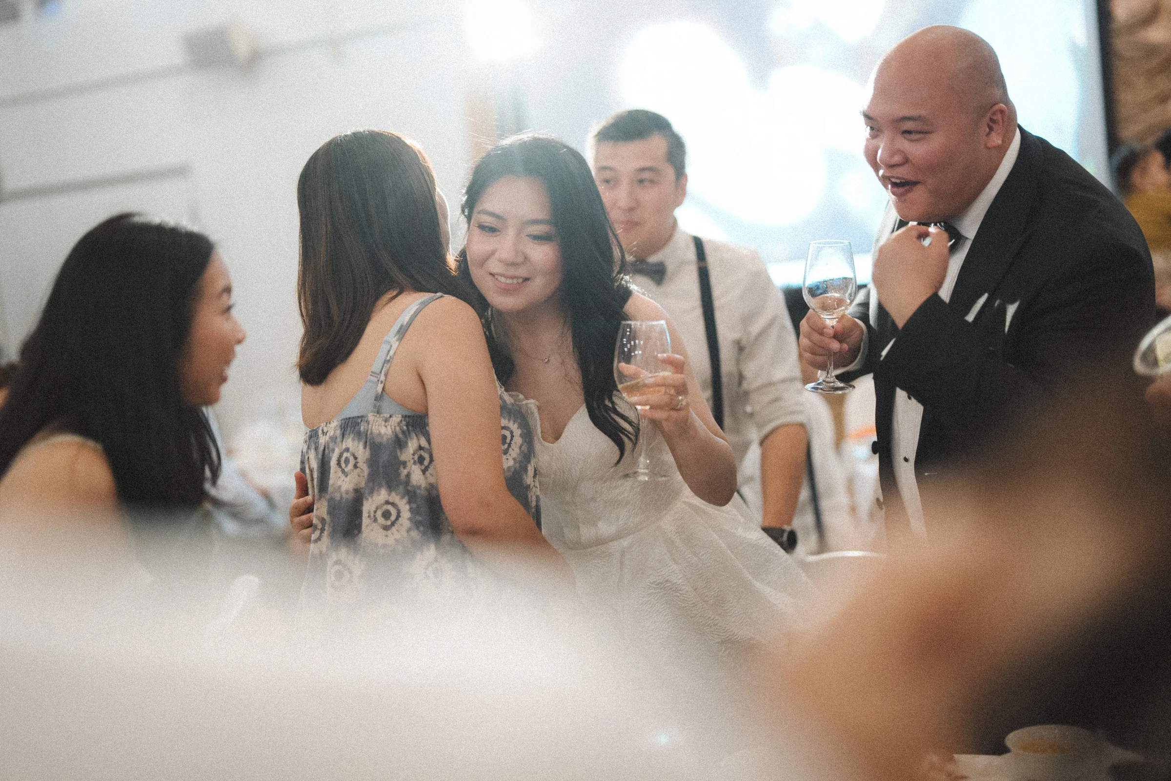 Friends smiling together during a table toast.