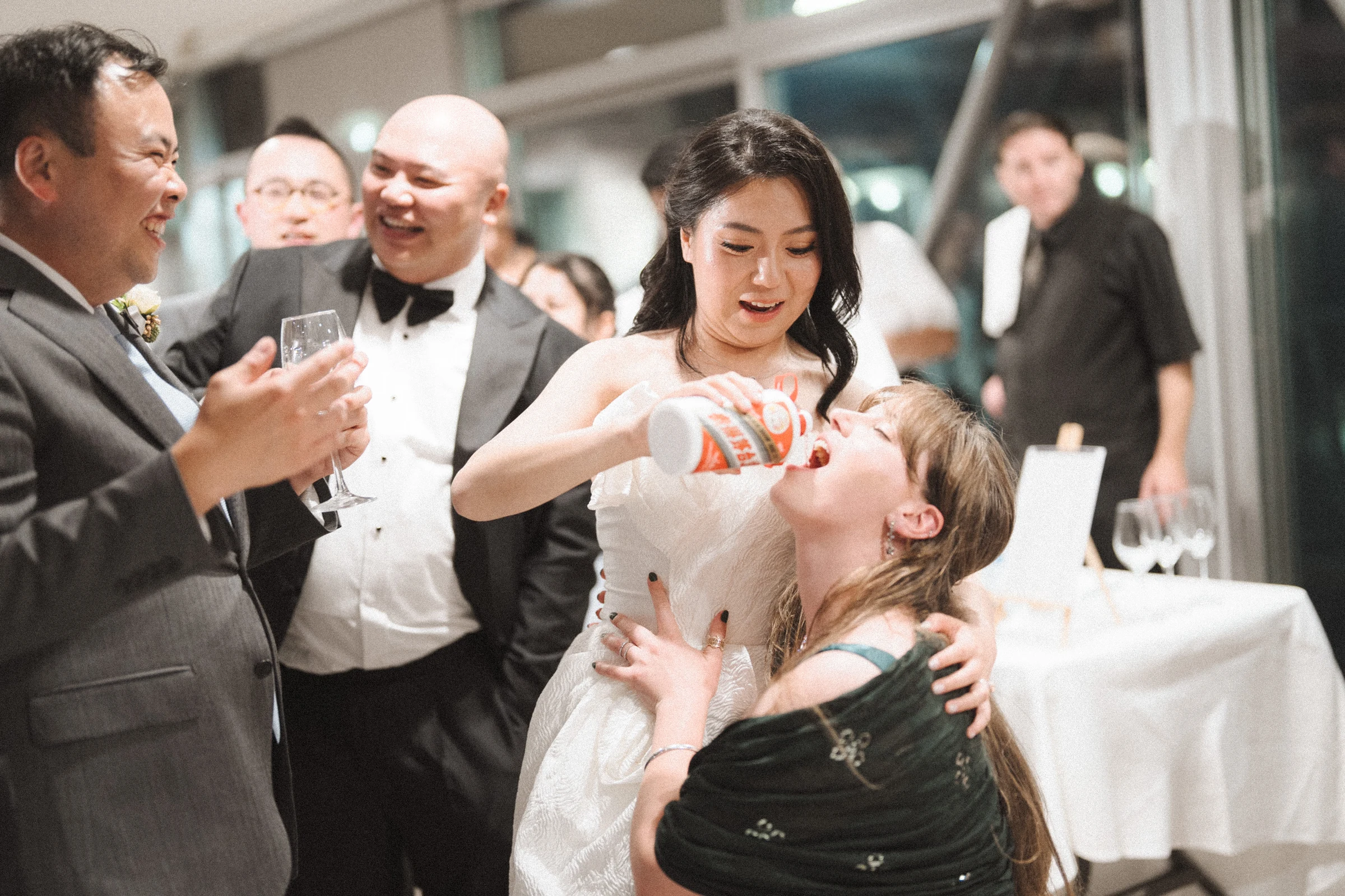 Bride dancing with a guest in the reception hall.