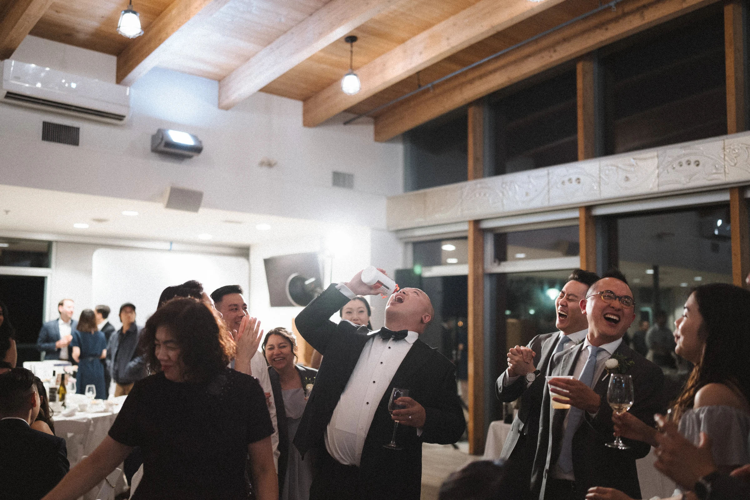 Wide view of guests and the couple gathering for the dances.