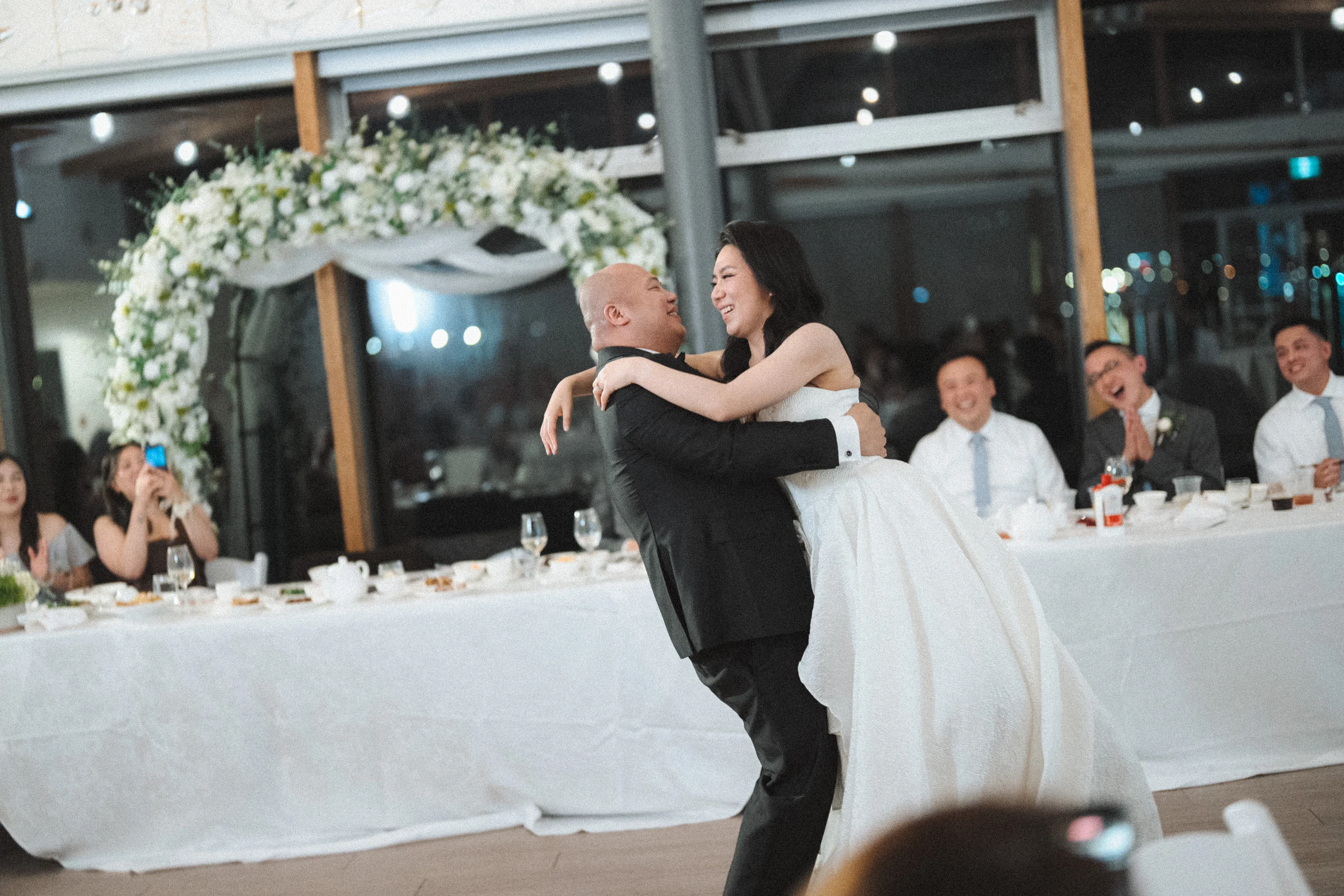 Bride embracing a guest on the dance floor.