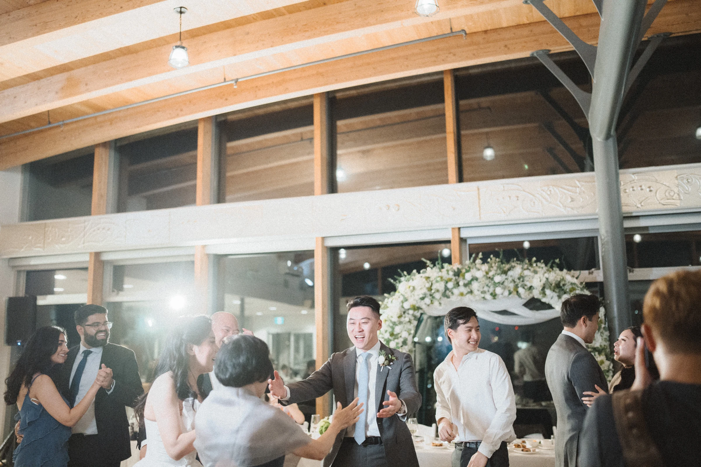 Guests gathering on the dance floor beneath the timber ceiling.