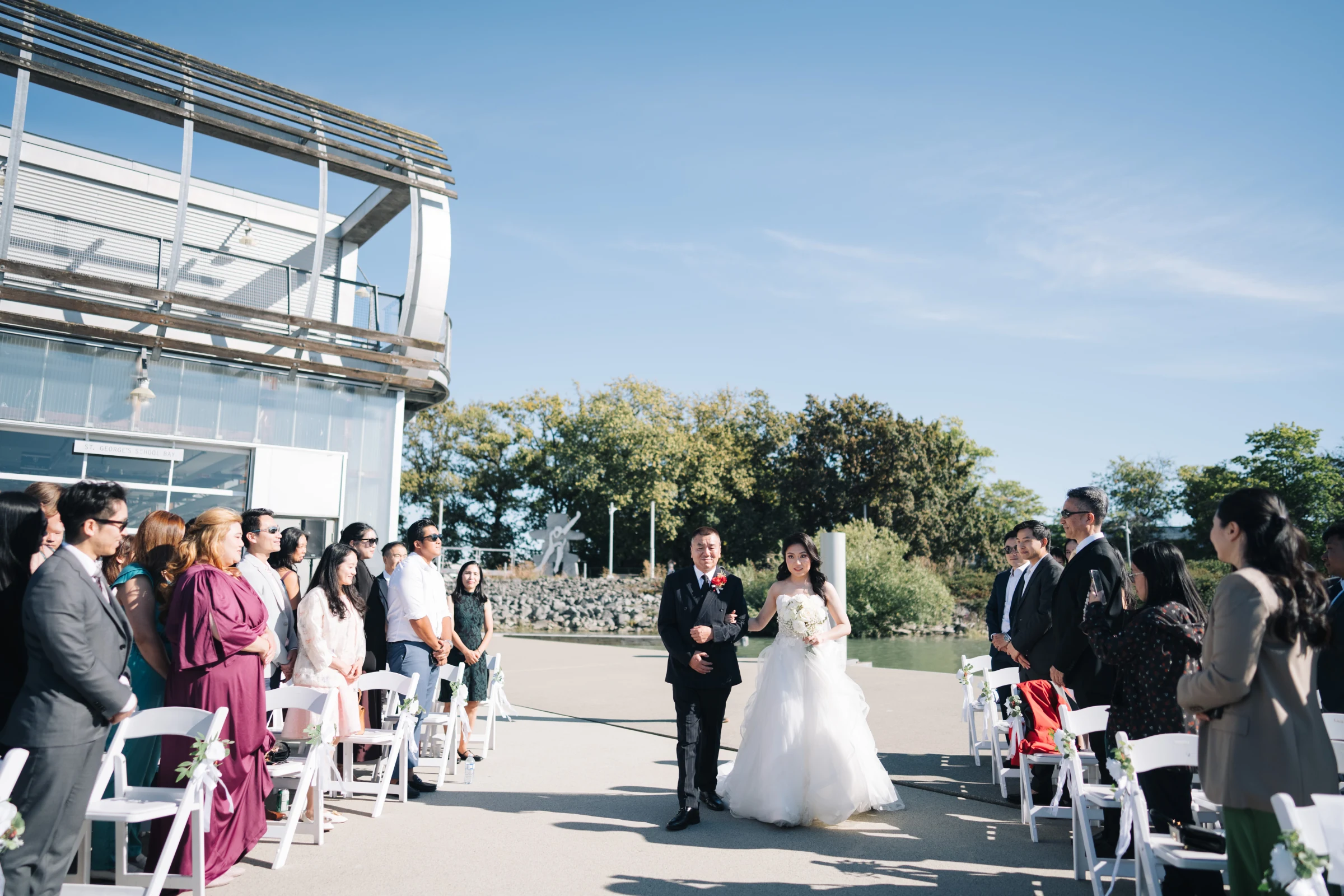 Lenora walking down the waterfront aisle with her father at UBC Boathouse in Richmond.