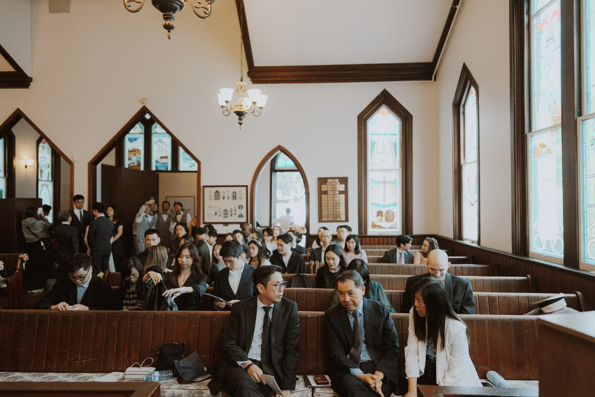 Guests waiting in Minoru Chapel's timber-trimmed ceremony room.