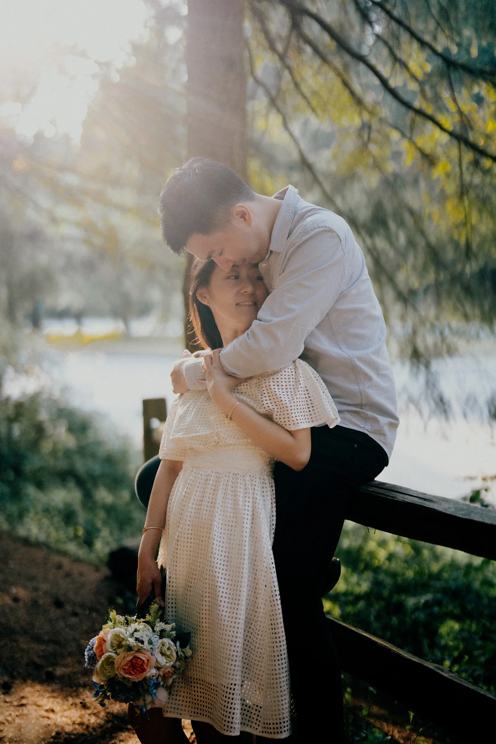 Intimate portrait of couple embracing, bride smiling with eyes closed, candid emotion.
