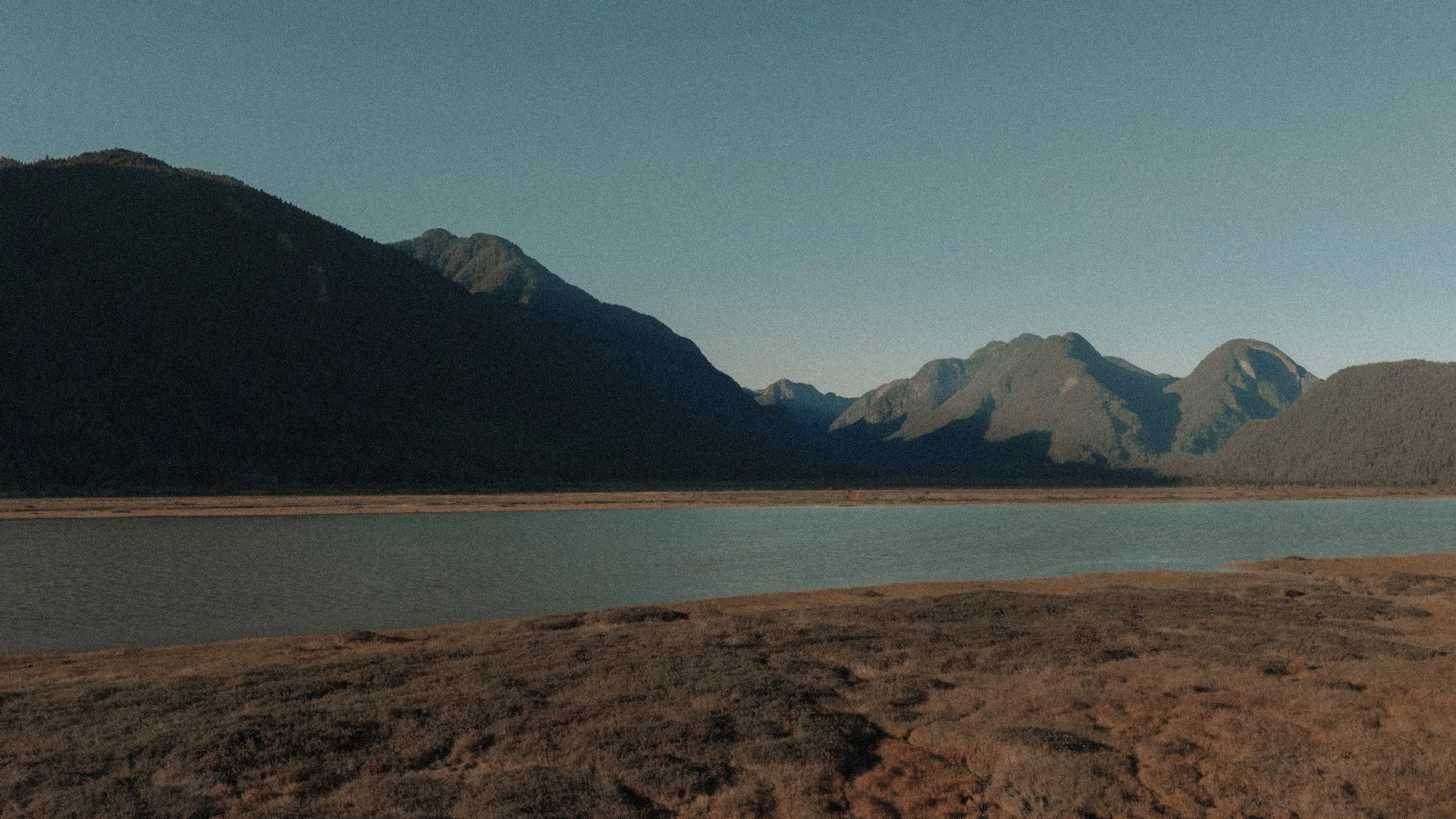 Wide landscape shot of Pitt Lake with mountains and water, Vancouver adventure backdrop.