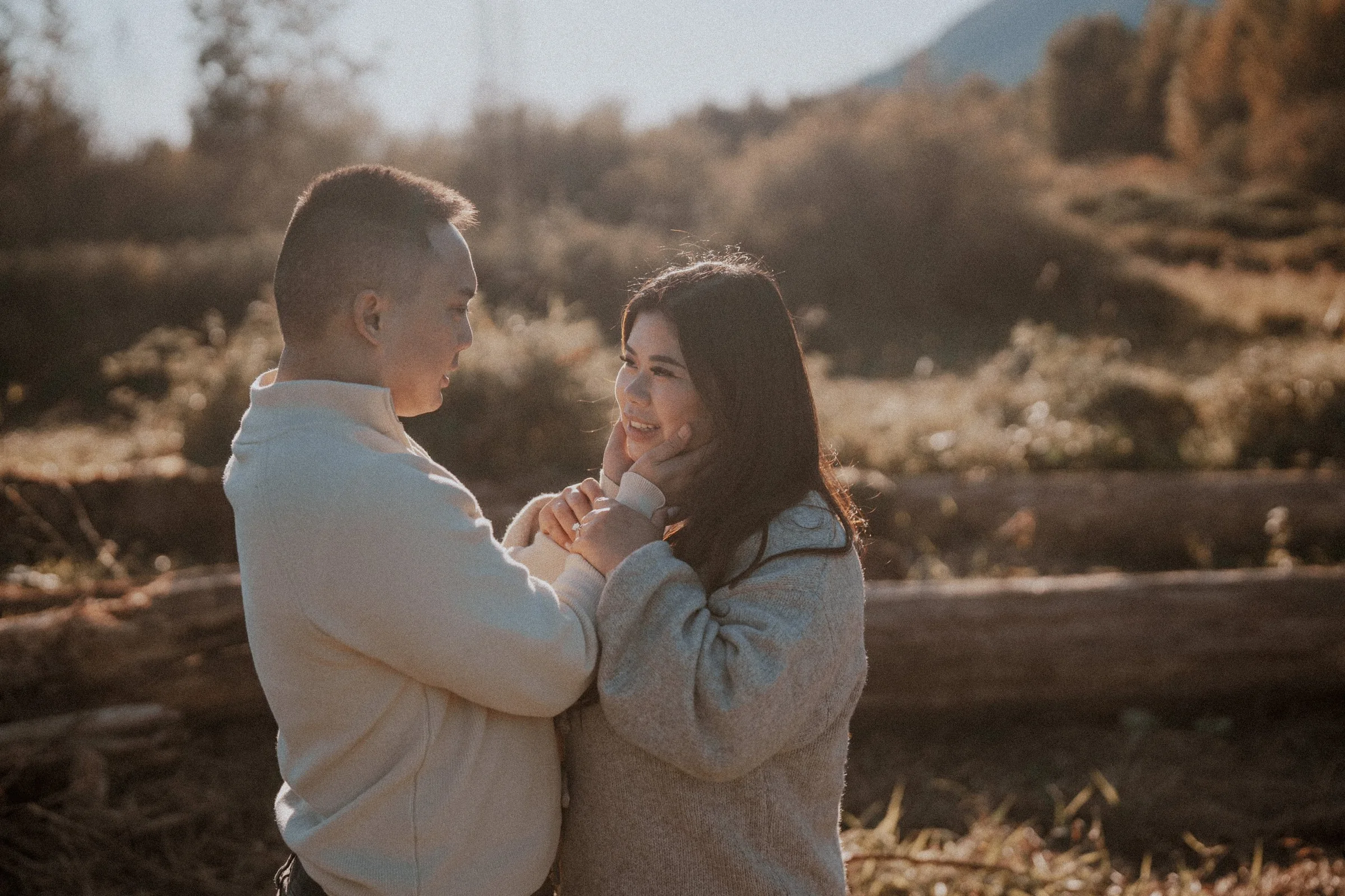 Close-up couple portrait, bride gently touching groom's face, candid connection.
