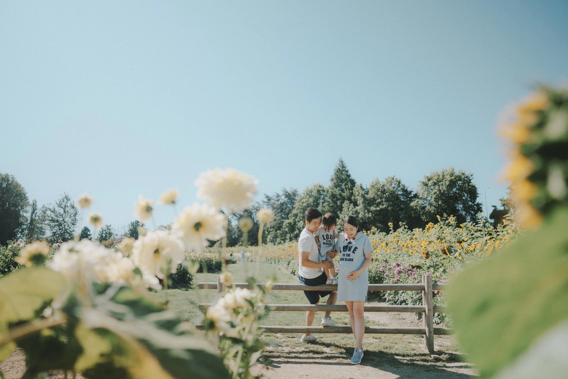 Family standing near fence in flower garden at Richmond Country Farms