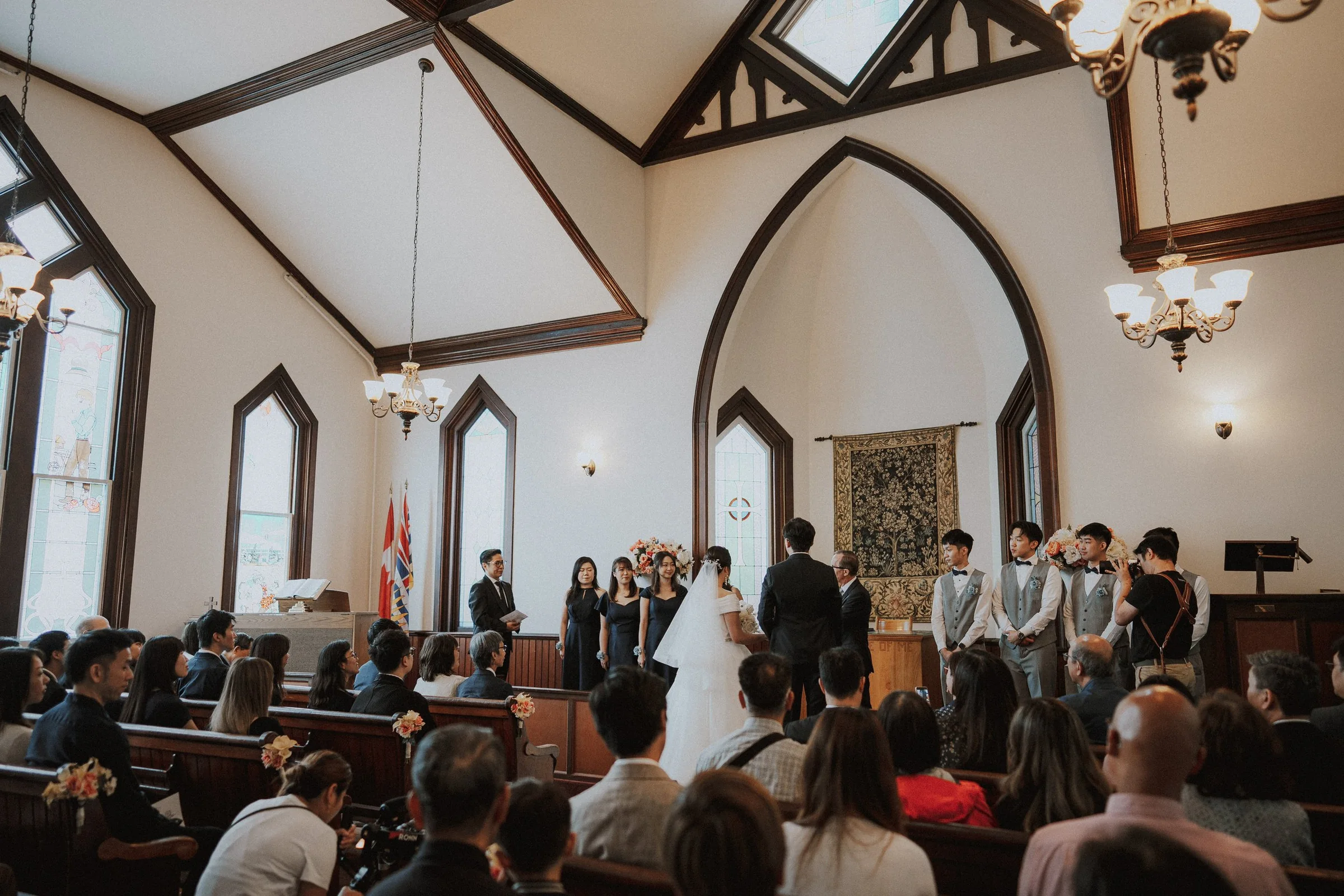 Wide view of the couple and wedding party during the Minoru Chapel ceremony.