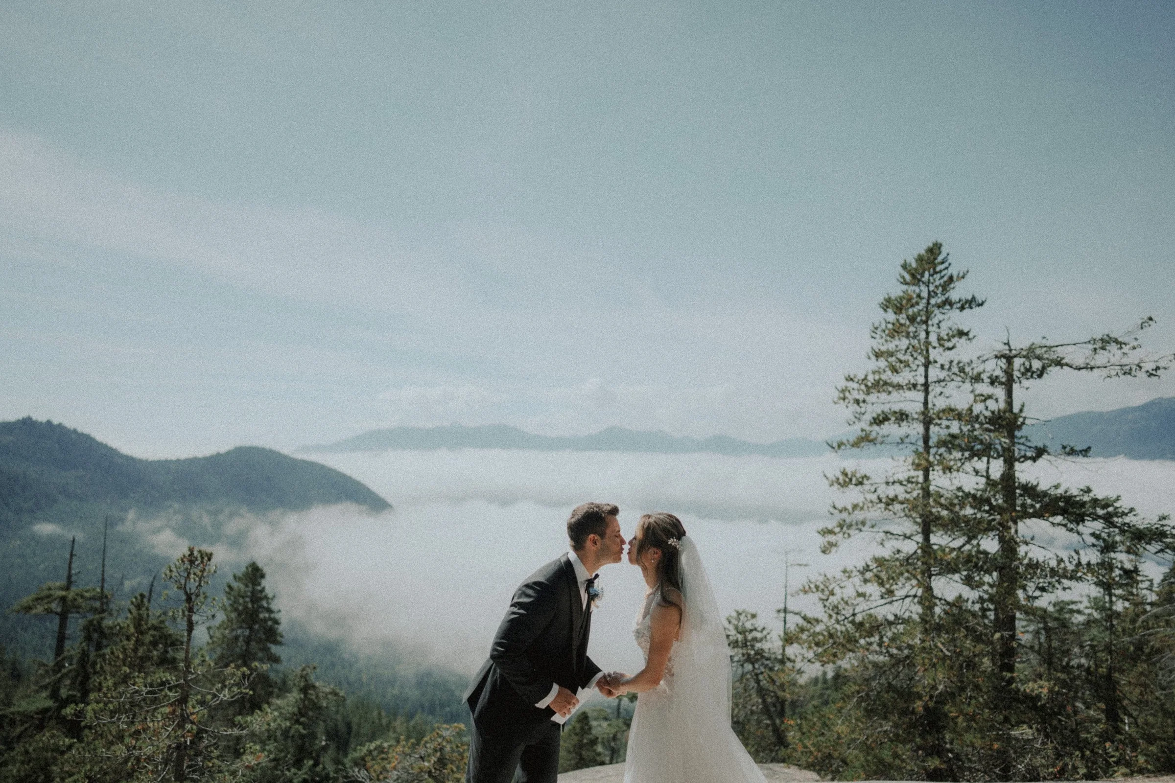 Newlyweds kissing during their Sea to Sky Gondola ceremony.