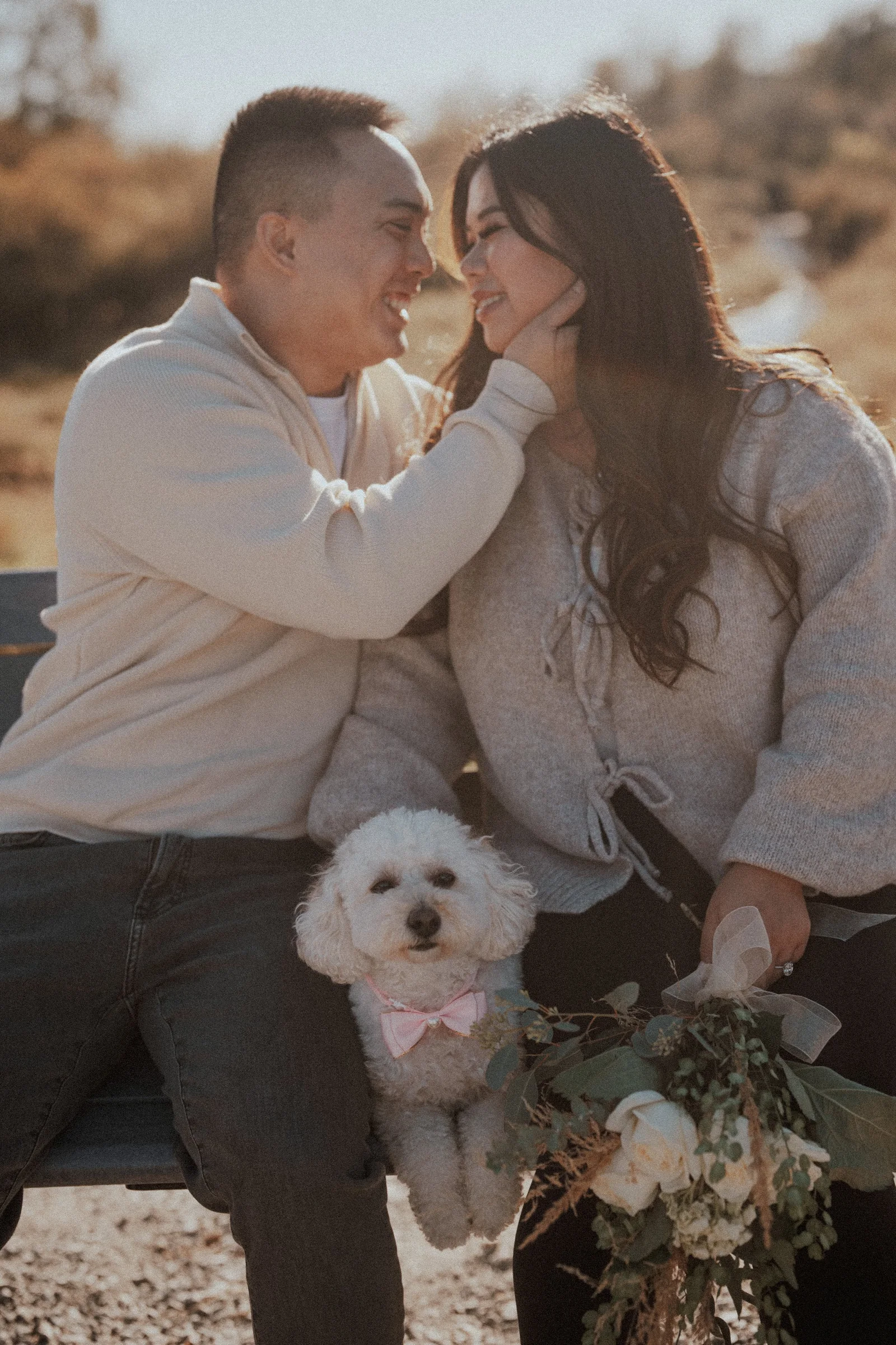 Couple with dog on bench, pet-friendly engagement, Pitt Lake backdrop.